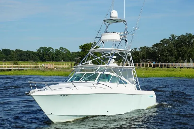 Slide: The Image of 2009 Contender 38 Express boat docked under clear blue sky. - 0