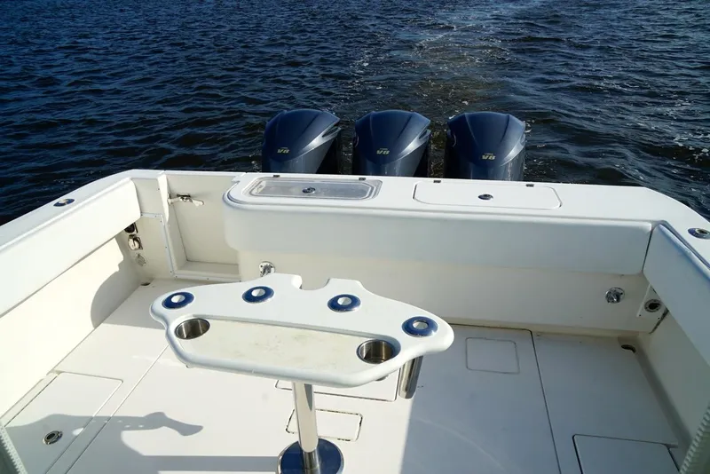 Slide: The Image of 2009 Contender 38 Express boat with triple outboard motors on open water. - 10