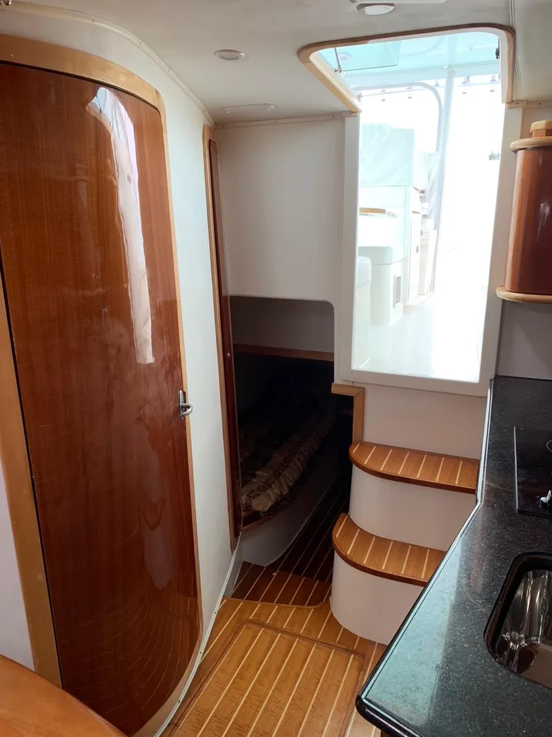 Slide: The Image of 2009 Contender 38 Express interior with wooden finishes and compact design. - 14