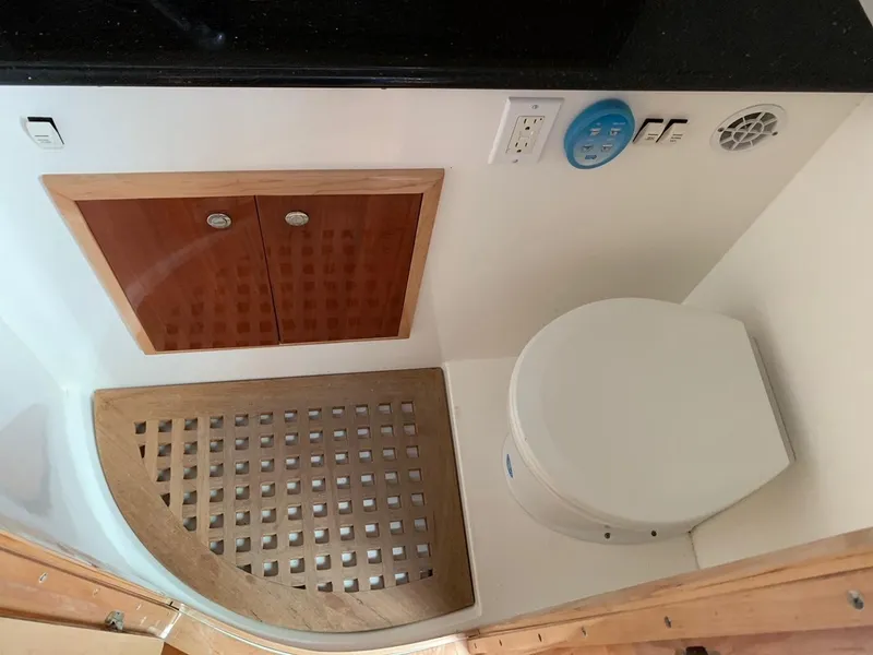 Slide: The Image of 2009 Contender 38 Express boat bathroom with wooden accents and modern fixtures. - 17