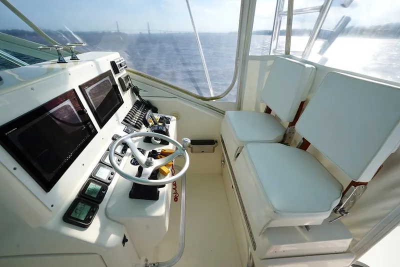 Slide: The Image of 2009 Contender 38 Express boat dashboard with steering wheel and navigation controls. - 5