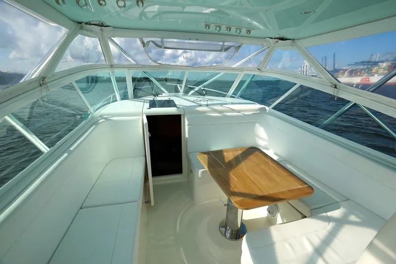 Slide: The Image of 2009 Contender 38 Express boat interior with seating and ocean view. - 7