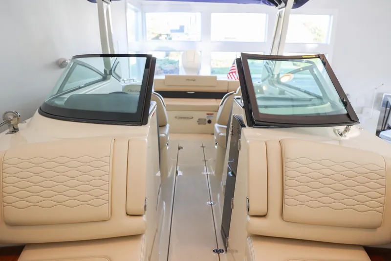 Slide: The Image of 2026 Chris-Craft Sportster 28 interior with beige seating and dual windshields. - 10