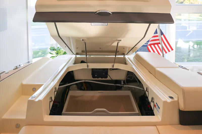 Slide: The Image of 2026 Chris-Craft Sportster 28 boat interior with open engine compartment and American flag. - 12