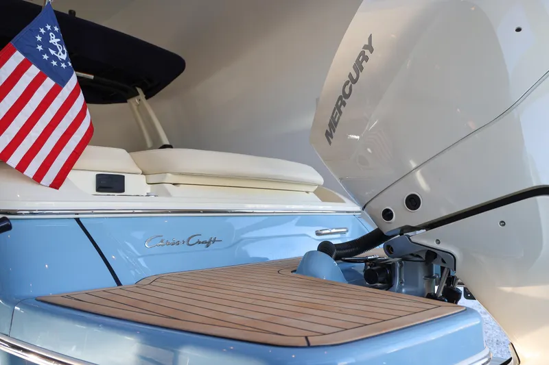 Slide: The Image of 2026 Chris-Craft Sportster 28 boat with Mercury engine and American flag. - 15