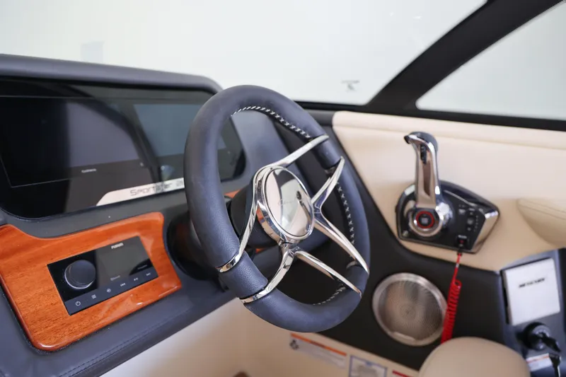 Slide: The Image of Interior of 2026 Chris-Craft Sportster 28, featuring sleek steering wheel and modern controls. - 7