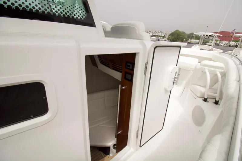 Slide: The Image of 2026 HCB 42 Lujo boat interior with open cabin door, showcasing sleek design. - 11