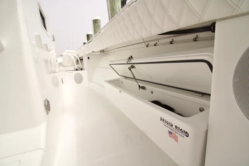 Slide: The Image of 2026 HCB 42 Lujo boat interior with open storage compartment and seating. - 12