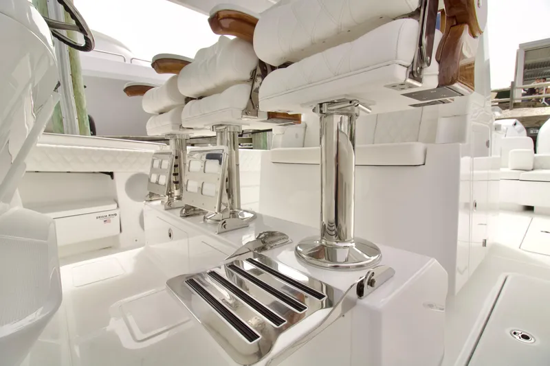 Slide: The Image of 2026 HCB 42 Lujo boat interior with luxurious white seating and chrome accents. - 16