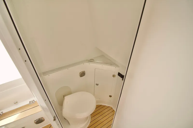 Slide: The Image of Interior of 2026 HCB 42 Lujo boat bathroom with toilet and wooden flooring. - 29