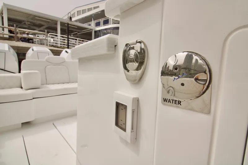 Slide: The Image of 2026 HCB 42 Lujo boat interior with water access panel and seating area. - 30