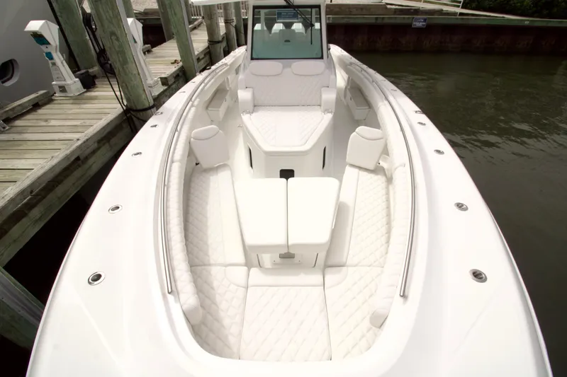 Slide: The Image of 2026 HCB 42 Lujo boat with luxurious white seating at dock. - 31