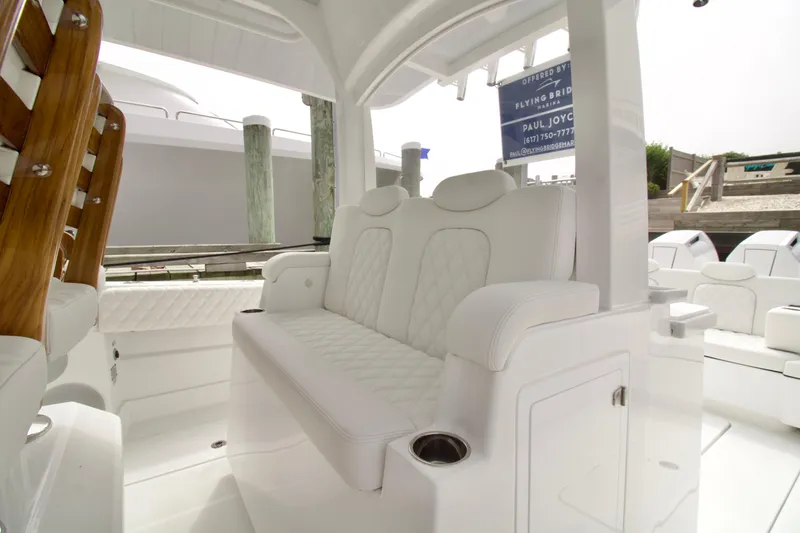 Slide: The Image of Luxury seating on 2026 HCB 42 Lujo boat, featuring white leather and wooden accents. - 36