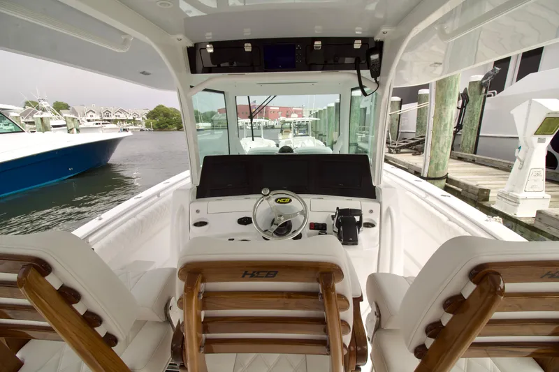 Slide: The Image of Interior view of 2026 HCB 42 Lujo boat with helm and seating. - 8
