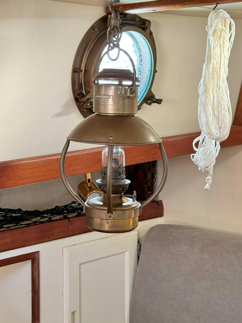 Slide: The Image of Vintage brass lantern inside a 1975 Westsail 32 sailboat cabin. - 27