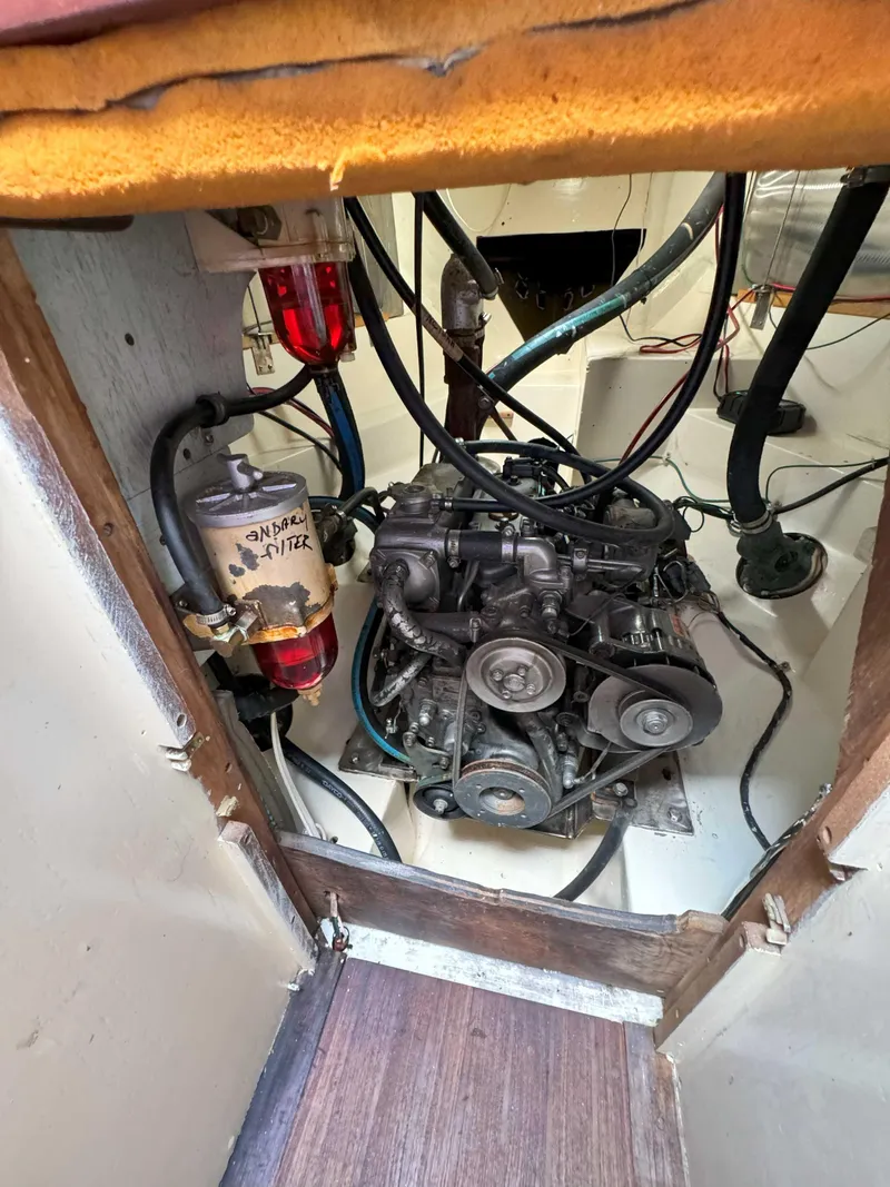 Slide: The Image of Engine compartment of a 1975 Westsail 32 sailboat, showing mechanical components and wiring. - 32