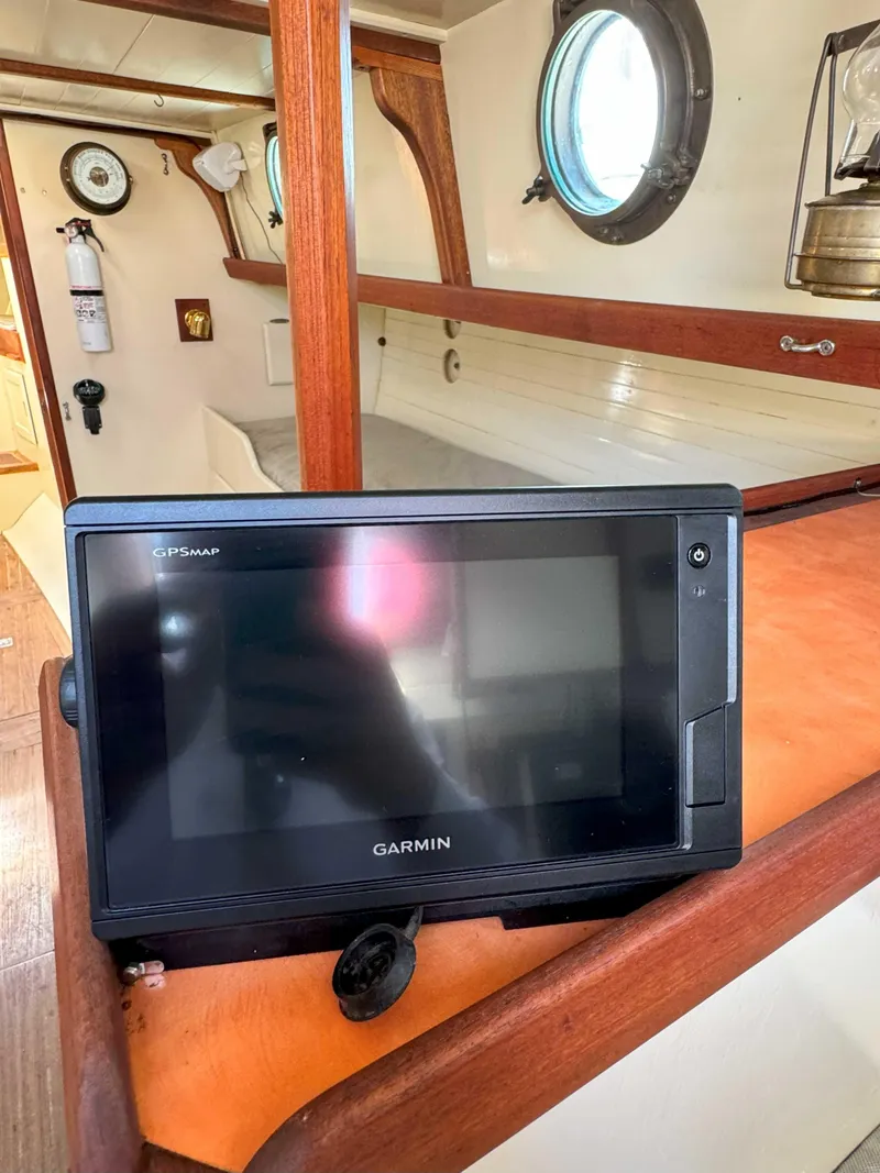 Slide: The Image of Garmin GPS device inside a 1975 Westsail 32 sailboat cabin with wooden interior. - 36