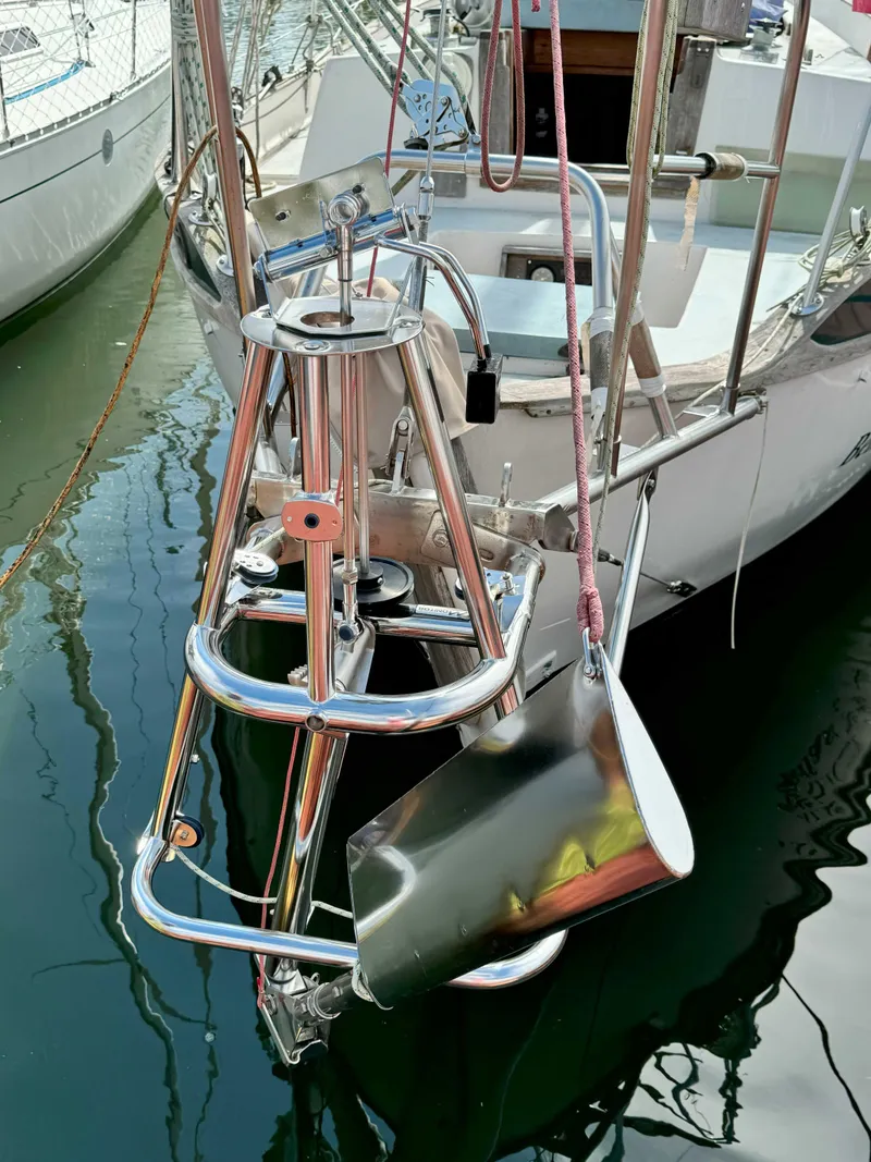 Slide: The Image of 1975 Westsail 32 sailboat with stainless steel bow pulpit and anchor in marina. - 4