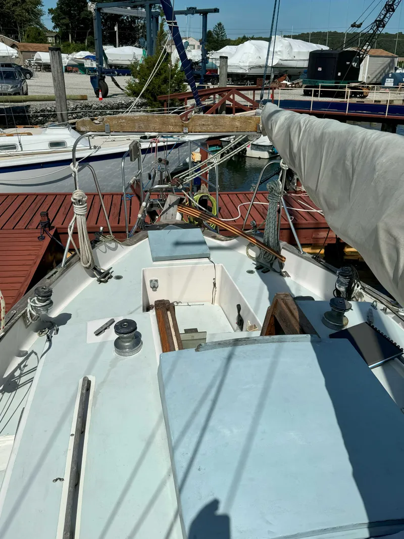 Slide: The Image of 1975 Westsail 32 sailboat docked, featuring deck and rigging details. - 6