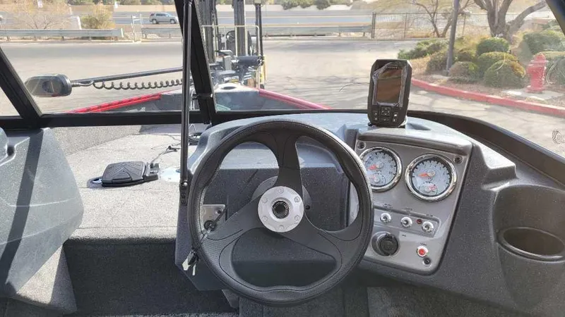 Slide: The Image of 2025 Tracker Pro Guide V-16 WT boat dashboard with steering wheel and gauges. - 10