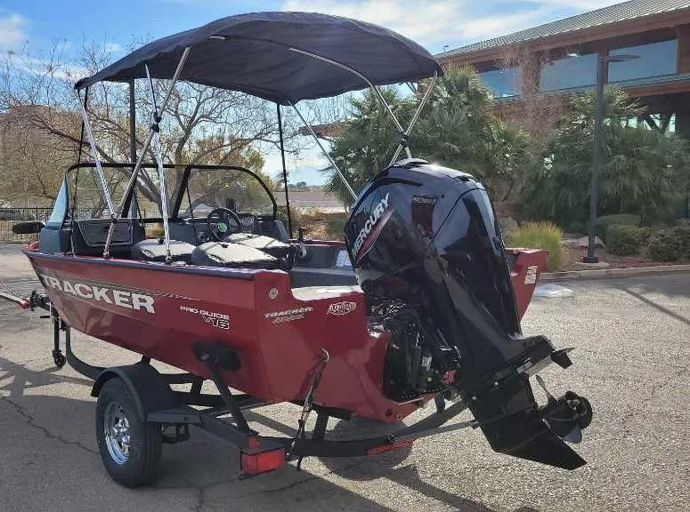 Slide: The Image of 2025 Tracker Pro Guide V-16 WT boat with Mercury outboard motor on trailer. - 4
