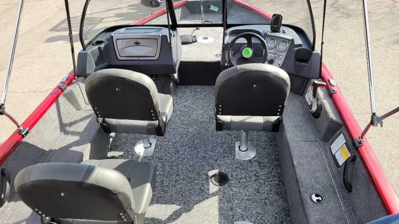 Slide: The Image of 2025 Tracker Pro Guide V-16 WT boat interior with seating and steering console. - 6
