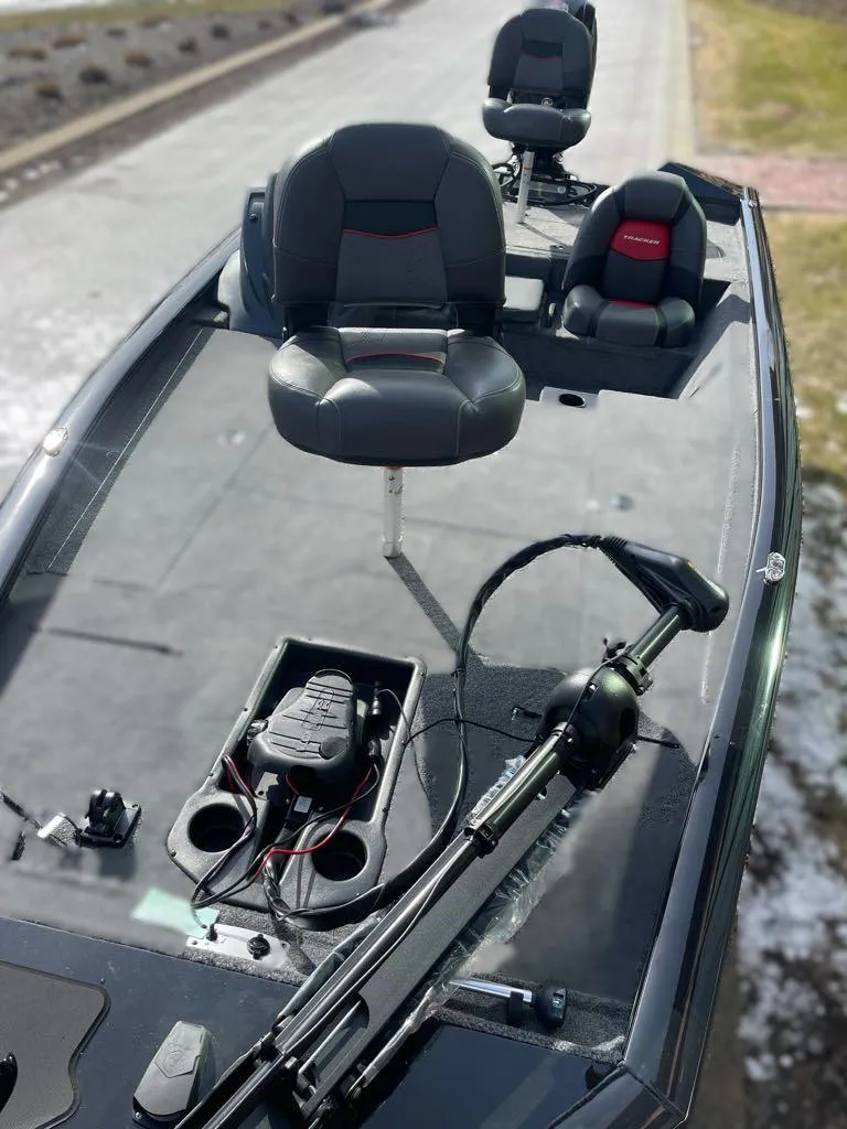 Slide: The Image of 2025 Tracker Pro Team 195 Tournament Edition boat with seating and fishing equipment. - 2