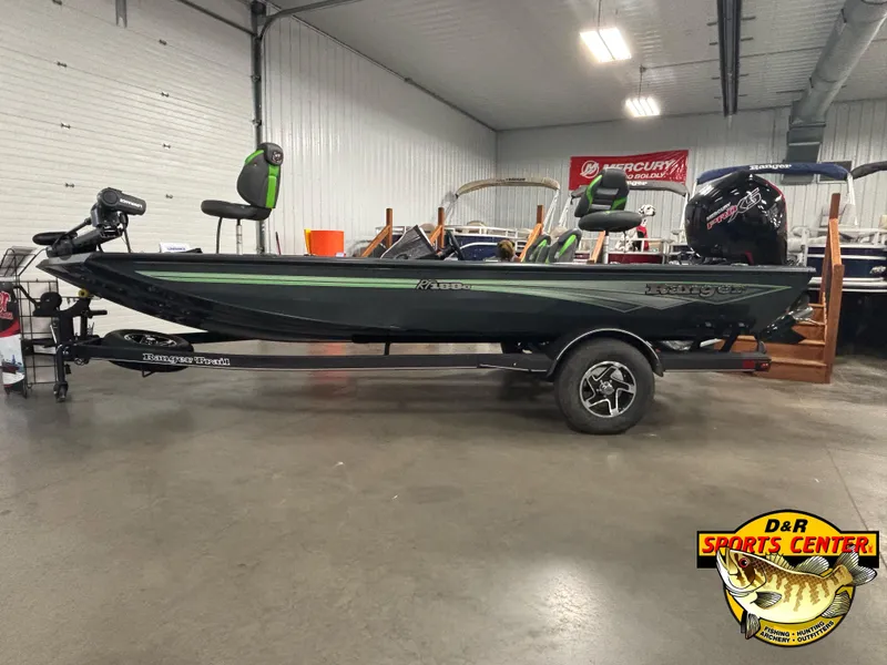 Slide: The Image of 2025 Ranger RT188C fishing boat on trailer in showroom, featuring sleek design and modern equipment. - 2