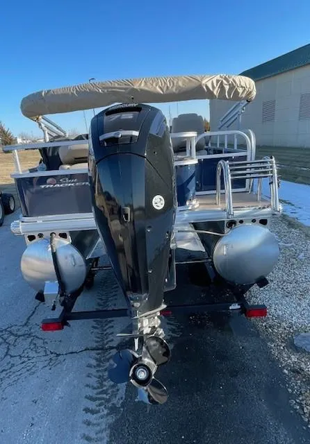 Slide: The Image of 2025 Sun Tracker Bass Buggy 18 DLX pontoon boat with outboard motor, rear view. - 3