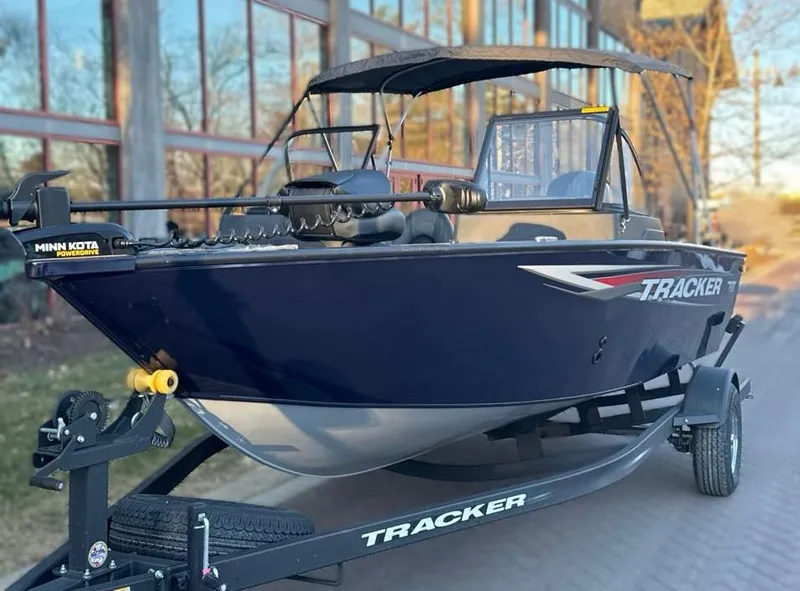 Slide: The Image of 2025 Tracker Pro Guide V-175 Combo boat on trailer, parked outdoors. - 3
