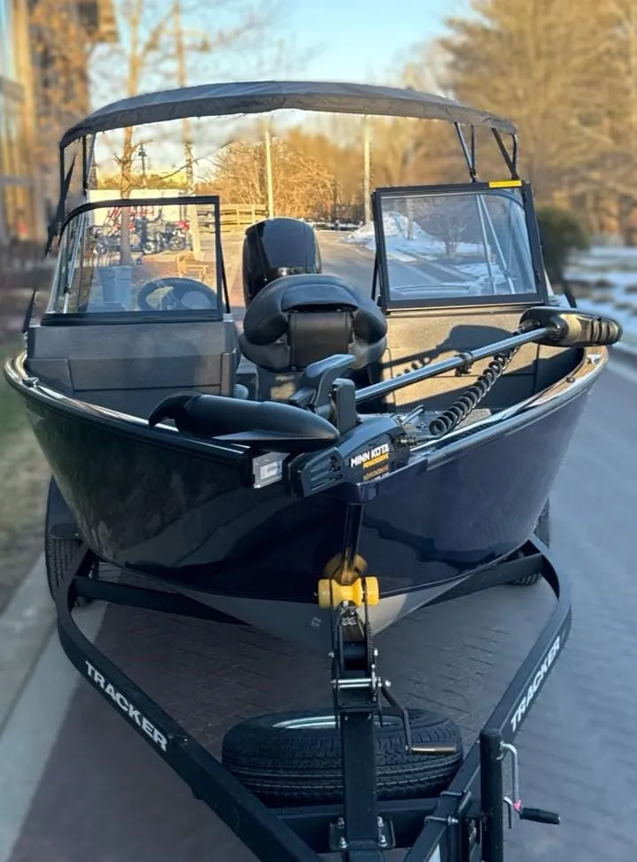 Slide: The Image of 2025 Tracker Pro Guide V-175 Combo boat on trailer, parked outdoors. - 4
