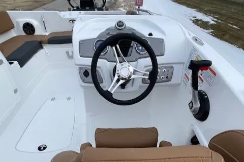 Slide: The Image of 2025 Tahoe 2150 boat interior with steering wheel and control panel. - 3