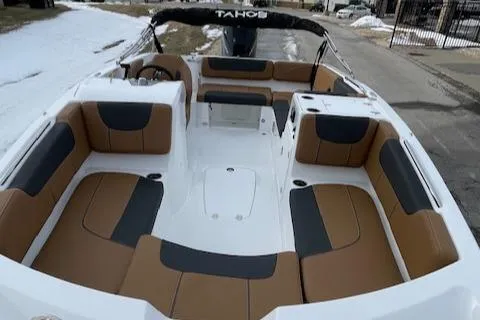 Slide: The Image of 2025 Tahoe 2150 boat interior with brown and black seating, docked on a snowy day. - 4