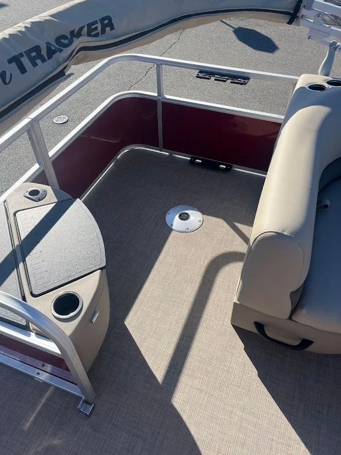 Slide: The Image of 2025 Sun Tracker Bass Buggy 18 DLX pontoon boat interior with seating and storage. - 2
