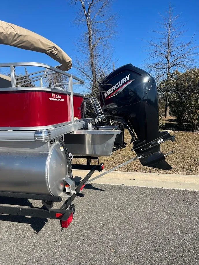 Slide: The Image of 2025 Sun Tracker Bass Buggy 18 DLX pontoon boat with Mercury outboard motor. - 4