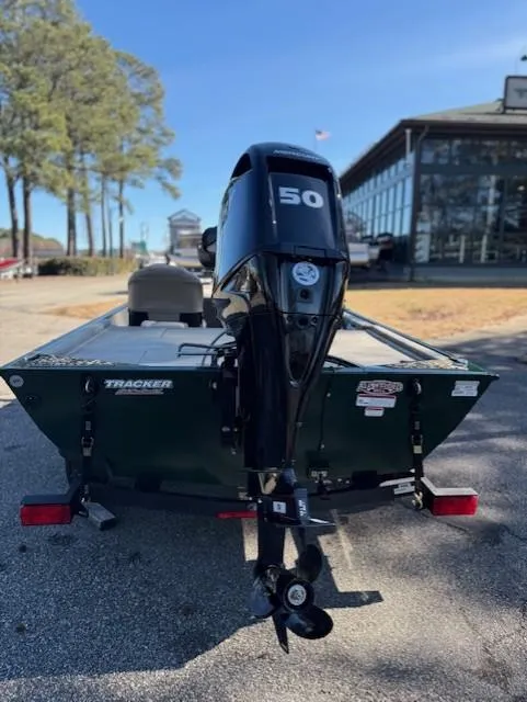 Slide: The Image of 2025 Tracker Bass Tracker Classic Limited boat with 50 HP motor, parked outdoors. - 40