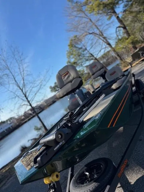 Slide: The Image of 2025 Tracker Bass Tracker Classic Limited boat by a serene lake. - 42
