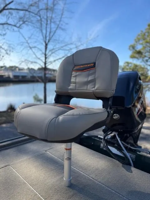 Slide: The Image of 2025 Tracker Bass Tracker Classic Limited boat seat by a serene lake. - 44