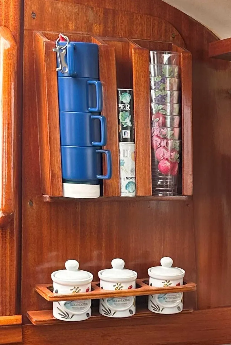 Slide: The Image of Wooden cabinet with blue mugs and decorative jars on a 1969 Contest 29 boat. - 10