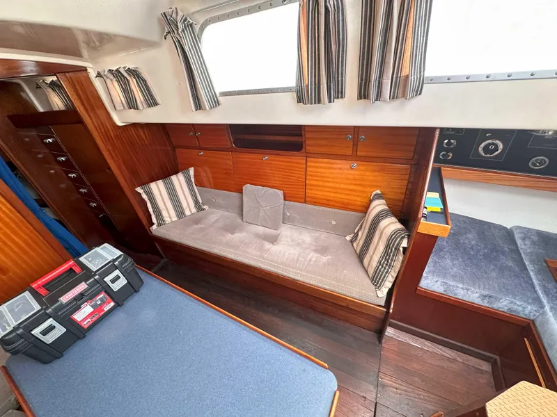 Slide: The Image of Interior of a 1969 Contest 29 sailboat with wood paneling and cozy seating area. - 11