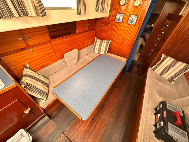 Slide: The Image of Interior of a 1969 Contest 29 sailboat with cozy seating and wooden paneling. - 12