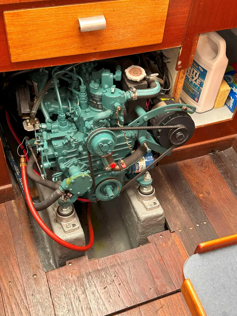 Slide: The Image of Engine compartment of a 1969 Contest 29 sailboat, featuring a well-maintained marine engine. - 14