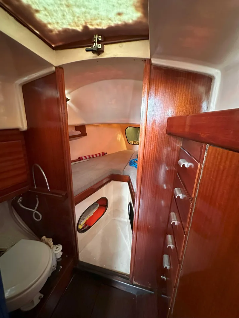 Slide: The Image of Interior of a 1969 Contest 29 sailboat, featuring wood paneling and compact cabin space. - 7