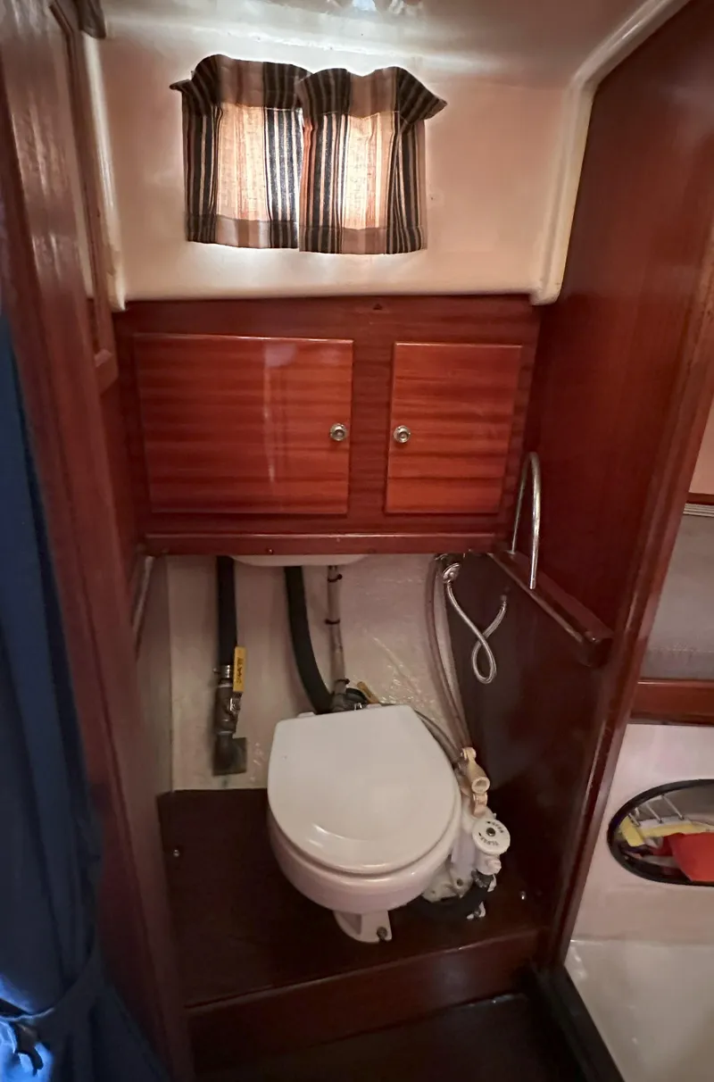 Slide: The Image of 1969 Contest 29 boat bathroom with wooden cabinets and compact toilet. - 8
