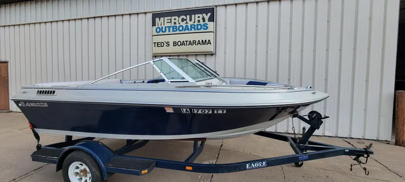 The Image of 1986 Four Winns 160 Freedom boat on trailer, parked outside Ted's Boatarama. - 0