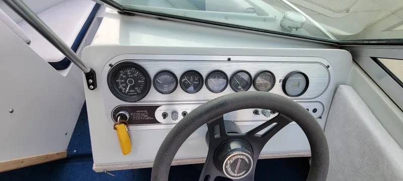Slide: The Image of 1986 Four Winns 160 Freedom dashboard with steering wheel and instrument panel. - 10