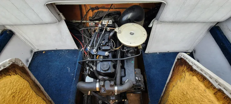 Slide: The Image of 1986 Four Winns 160 Freedom boat engine compartment with visible engine components. - 5
