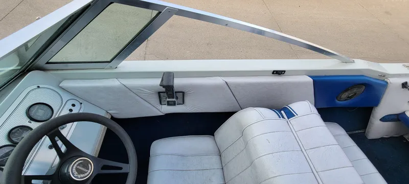 Slide: The Image of 1986 Four Winns 160 Freedom boat interior with steering wheel and seating. - 9