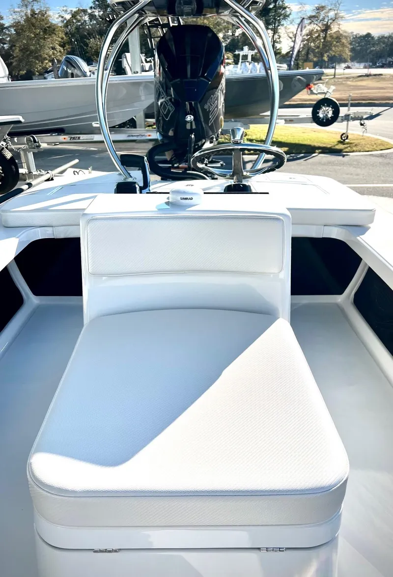 Slide: The Image of 2025 Chittum Skiffs 21R boat interior with white seating and steering console. - 5