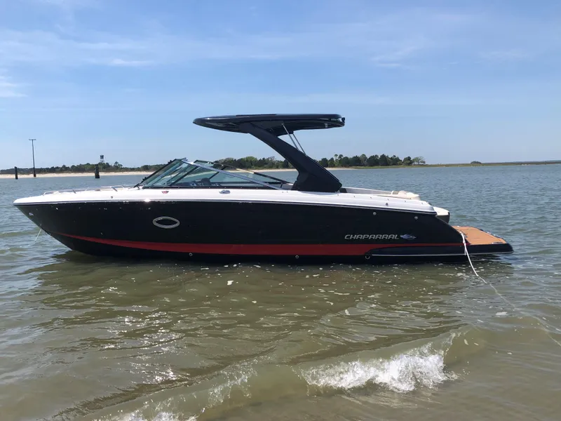 Slide: The Image of 2019 Chaparral 297 SSX boat on calm water, side view. - 2